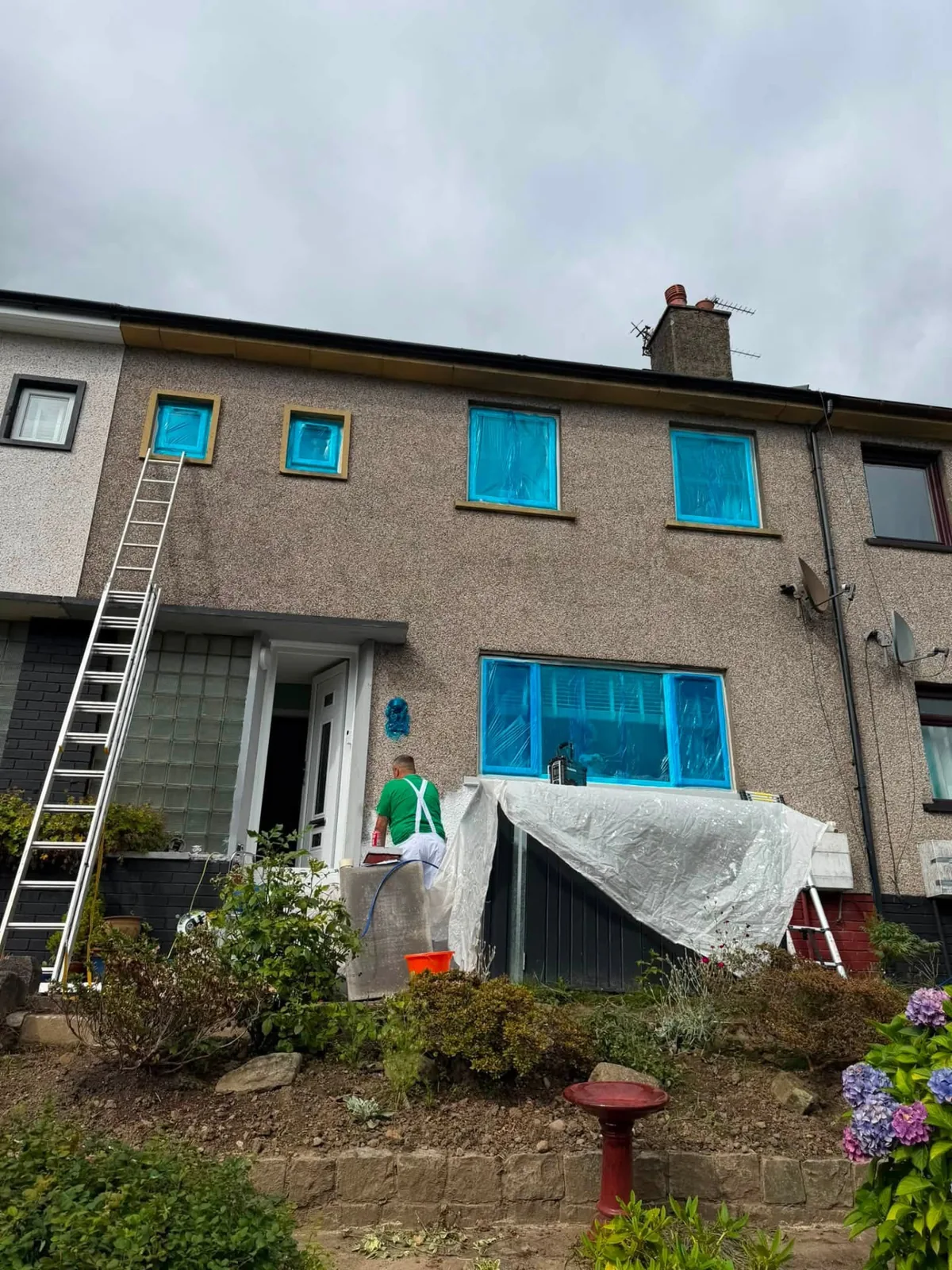 Masked windows prepared for professional exterior spray painting